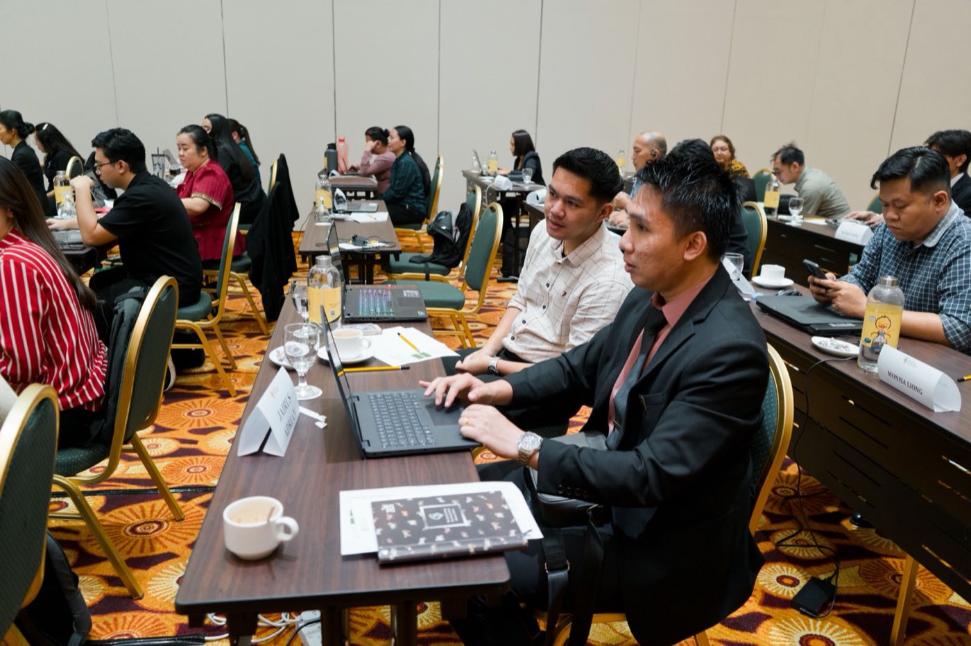 Participants applying AI tools on their laptops during an AI Confidence workshop led by Sylvia Avila in Bintulu, Malaysia