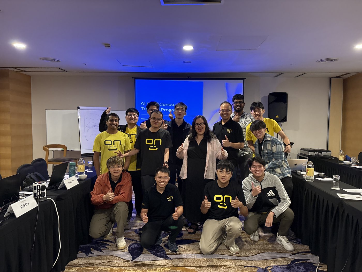 A technology team giving thumbs up with Sylvia Avila after an AI Confidence workshop in Kuala Lumpur, Malaysia